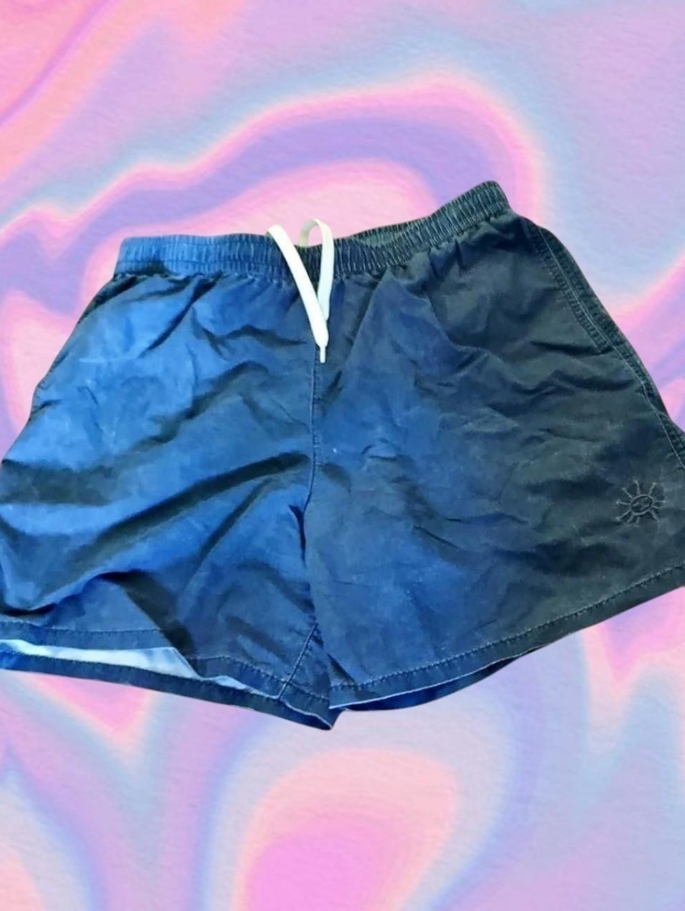 blue swim trunks from urban outfitters with sun logo at the bottom size medium